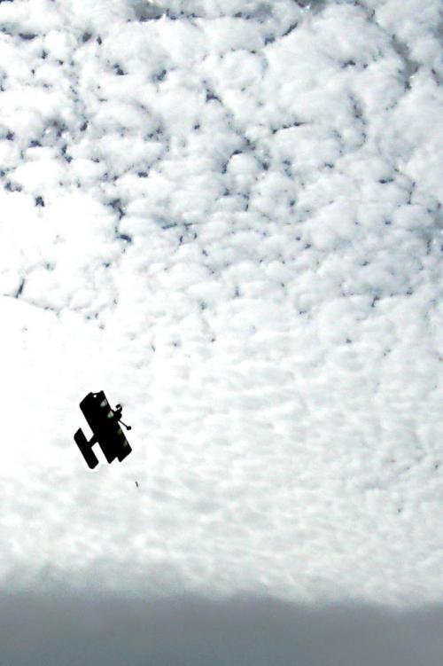 Biplane against a mackrel sky.